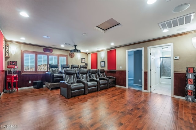 cinema room featuring ornamental molding and hardwood / wood-style flooring