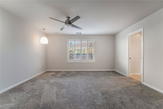 empty room featuring ceiling fan and light colored carpet