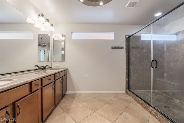 bathroom with tile patterned floors, a shower with door, and vanity