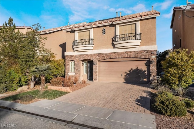 mediterranean / spanish house featuring a balcony and a garage