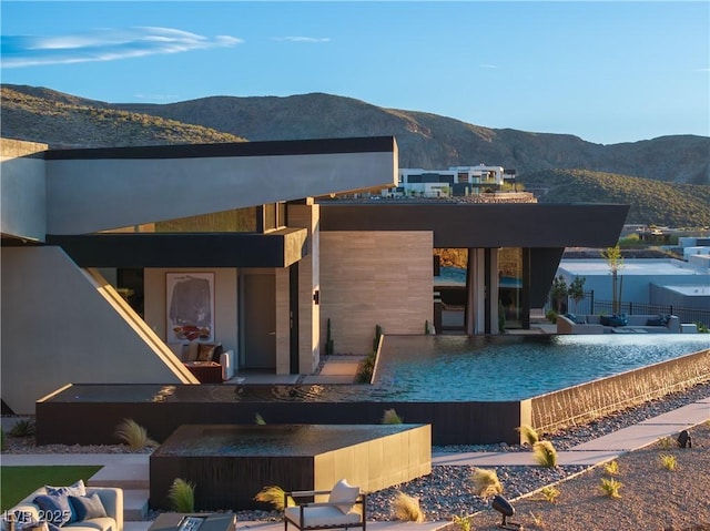 back of property with a patio area and a mountain view