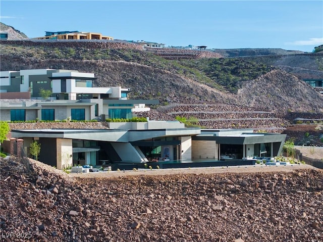 rear view of house featuring a mountain view