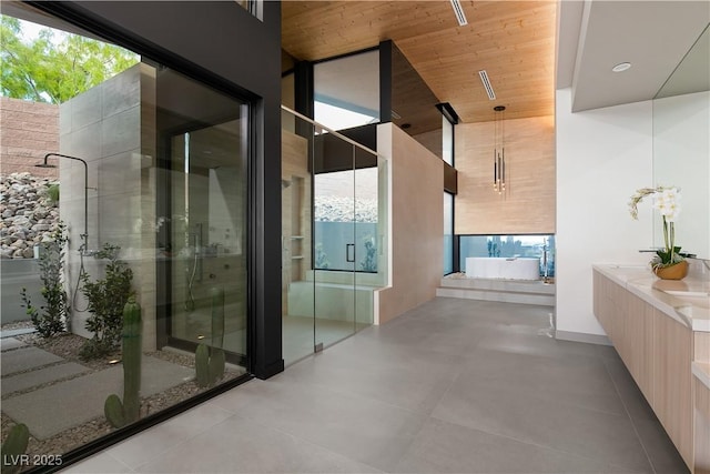 bathroom with vanity, a shower with door, and wood ceiling