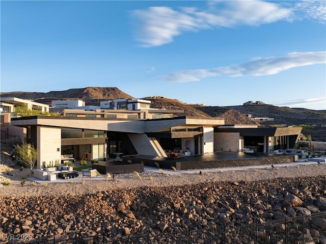 rear view of property with a mountain view