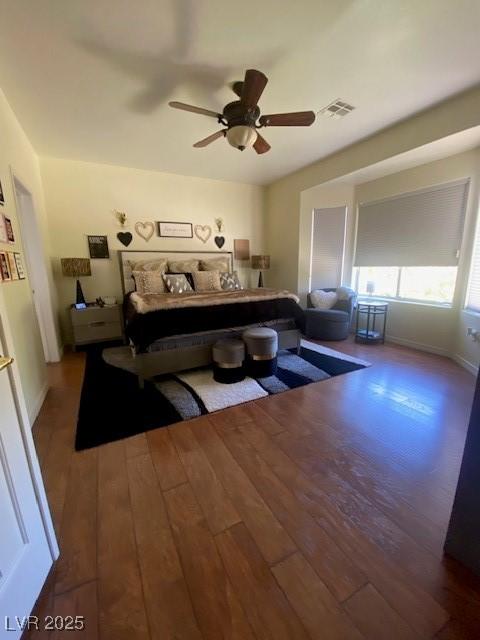 bedroom with ceiling fan and dark hardwood / wood-style floors