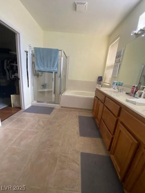 bathroom with vanity and independent shower and bath