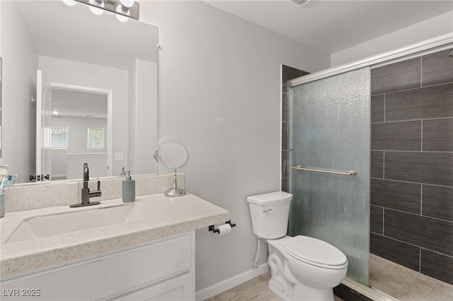 bathroom with vanity, an enclosed shower, and toilet