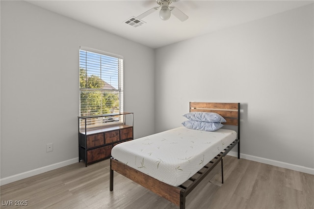 bedroom with ceiling fan and light hardwood / wood-style flooring