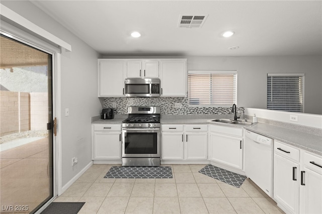 kitchen with white cabinetry, sink, and appliances with stainless steel finishes