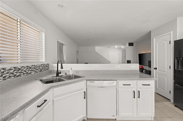 kitchen featuring white cabinetry, sink, black refrigerator with ice dispenser, white dishwasher, and light tile patterned flooring