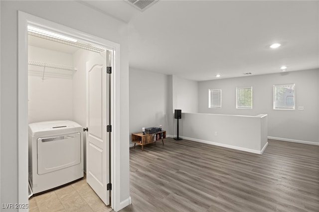 laundry room with light wood-type flooring and washer / clothes dryer