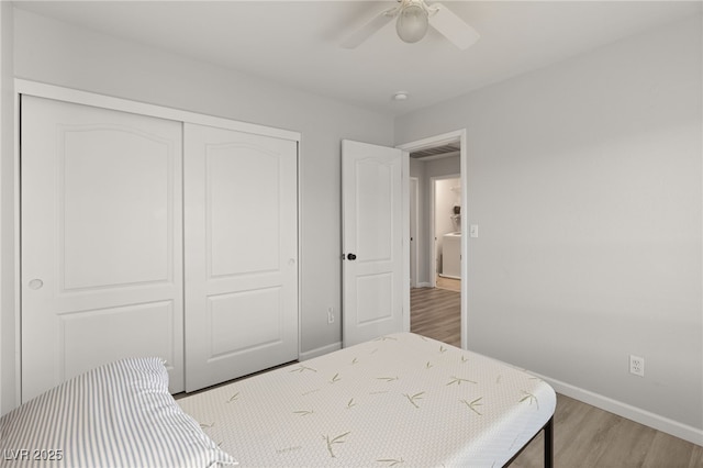 bedroom with light hardwood / wood-style flooring, a closet, and ceiling fan