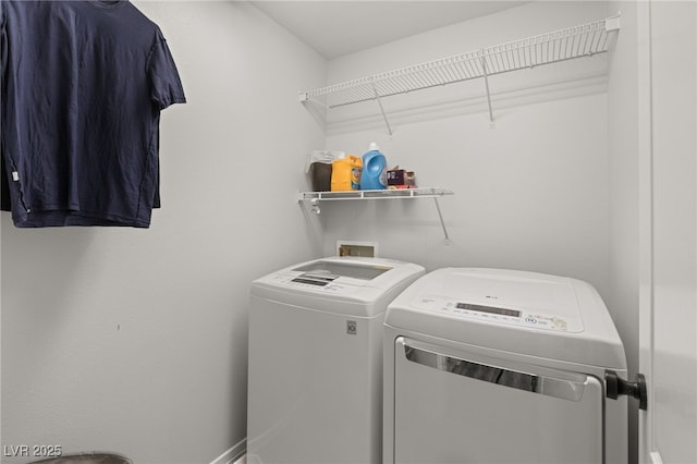 clothes washing area with washer and clothes dryer