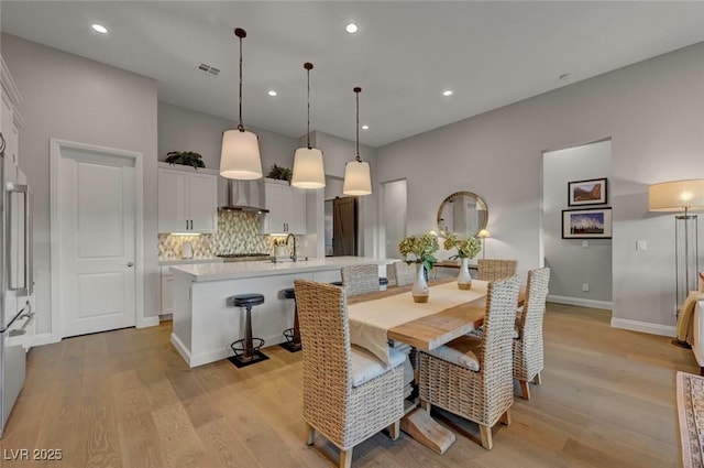 dining room with light wood-type flooring and sink