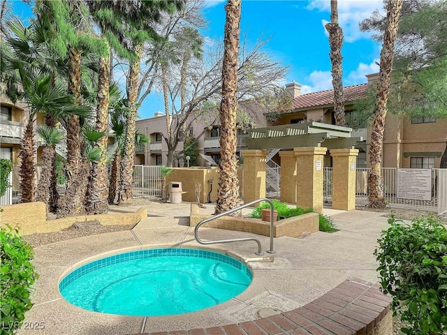 view of swimming pool featuring a community hot tub and a pergola