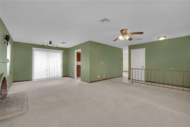 unfurnished living room with ceiling fan and light carpet