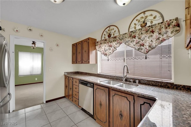 kitchen featuring sink, appliances with stainless steel finishes, and light carpet