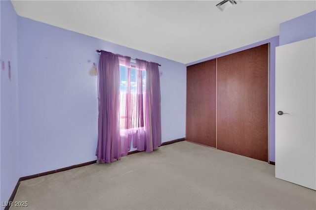 empty room featuring light carpet