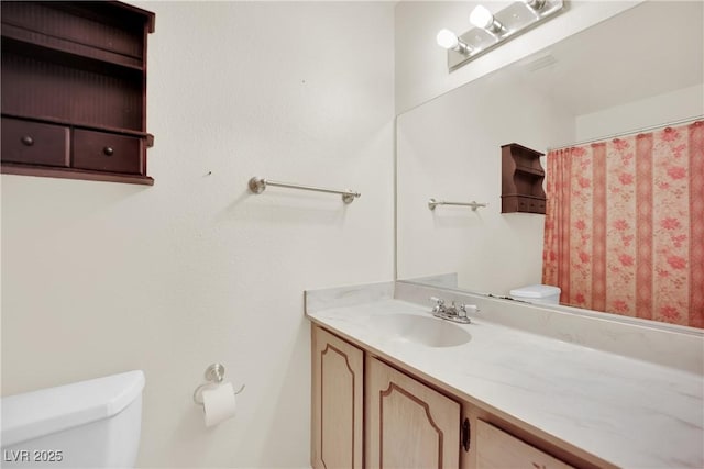 bathroom with vanity and toilet