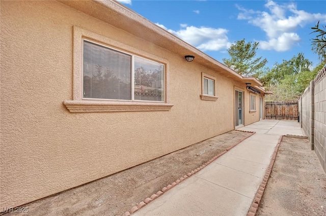 view of side of home with a patio