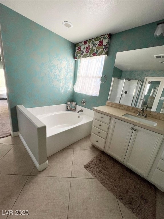 bathroom featuring tile patterned flooring, vanity, and shower with separate bathtub