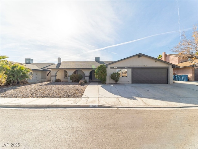 ranch-style home with a garage and central AC