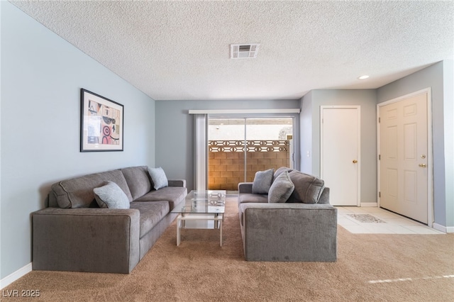 living room featuring a textured ceiling and light carpet