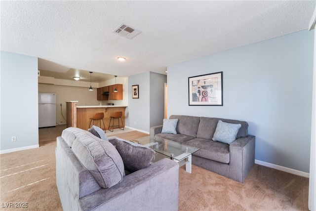 living room with light carpet and a textured ceiling