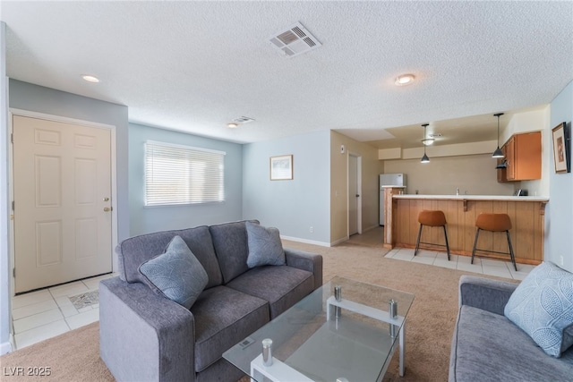 carpeted living room with a textured ceiling