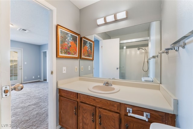 bathroom with a shower and vanity