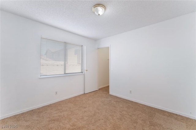 carpeted spare room featuring a textured ceiling