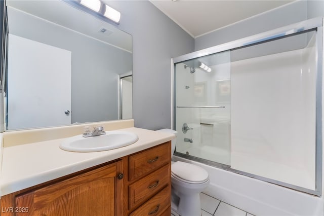 full bathroom with shower / bath combination with glass door, vanity, toilet, and tile patterned flooring