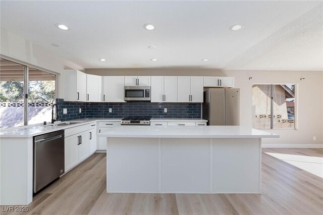 kitchen featuring sink, white cabinets, a center island, and appliances with stainless steel finishes