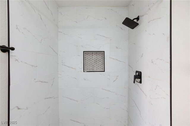 bathroom with a tile shower