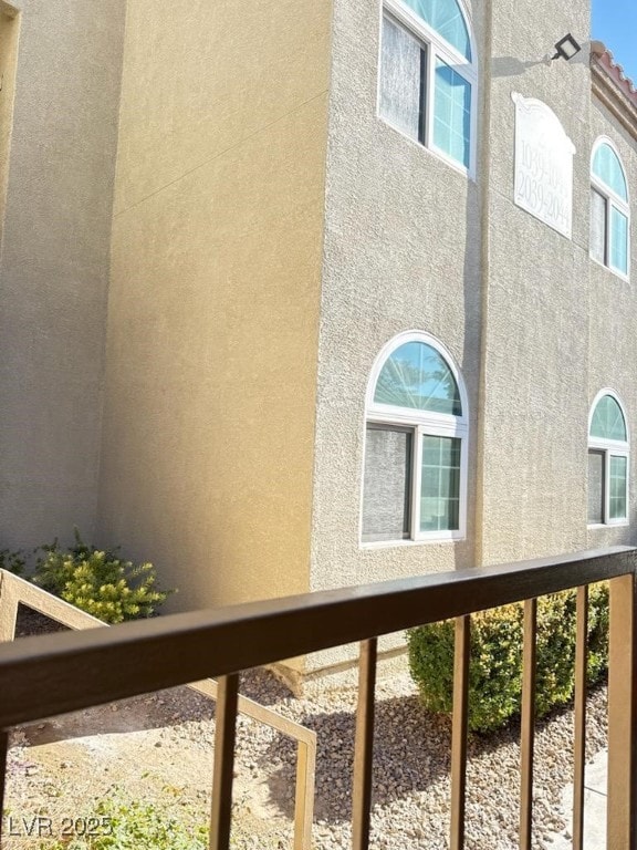 view of side of home with a balcony