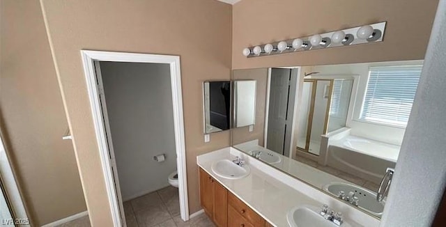 bathroom with toilet, tile patterned flooring, vanity, and a bathing tub