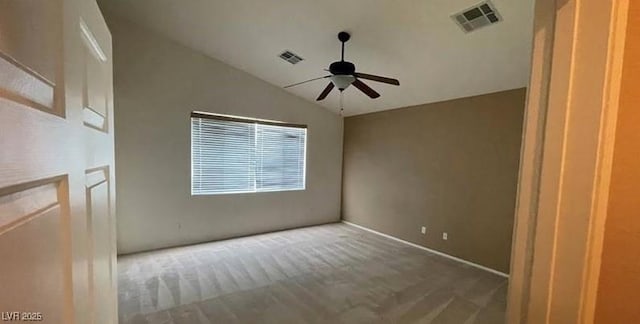 carpeted empty room with ceiling fan and vaulted ceiling