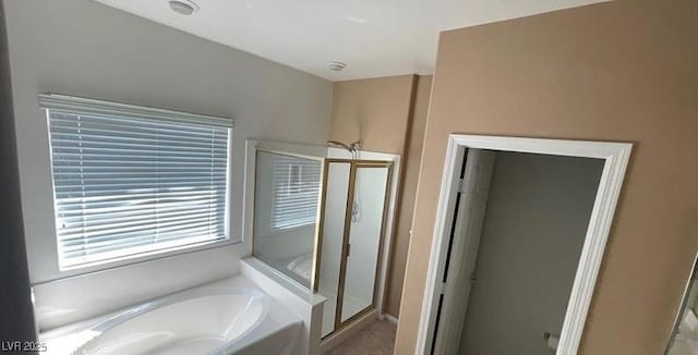 bathroom featuring separate shower and tub