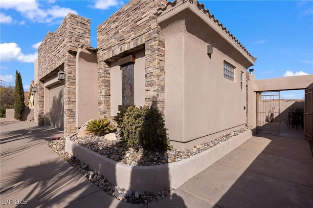 view of side of property with a garage