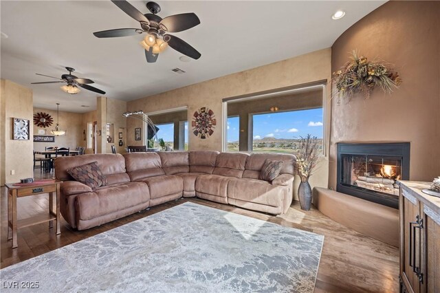 living room featuring dark hardwood / wood-style flooring and ceiling fan