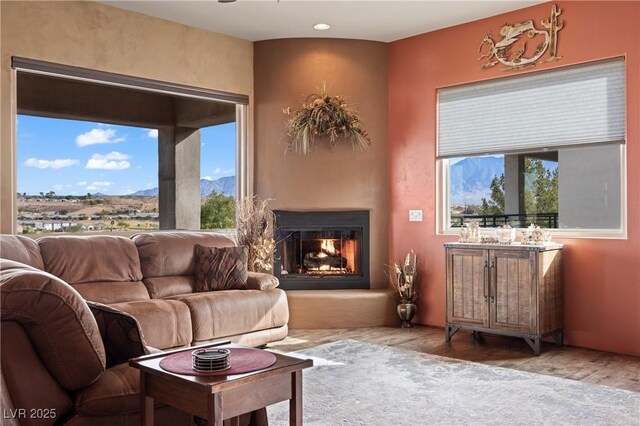 living room featuring a mountain view and hardwood / wood-style floors