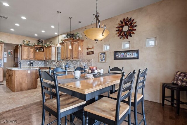 dining room featuring sink and wood-type flooring