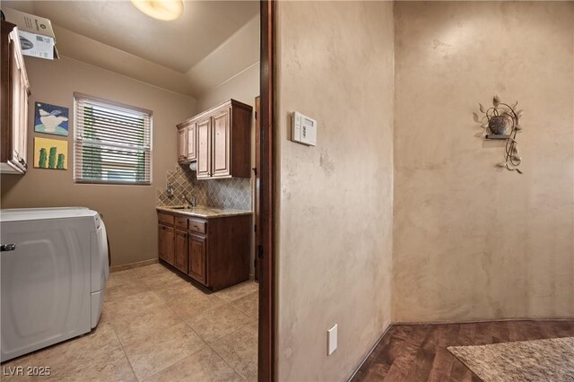 laundry area with cabinets and washer / dryer