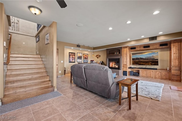 living room with tile patterned floors and built in shelves