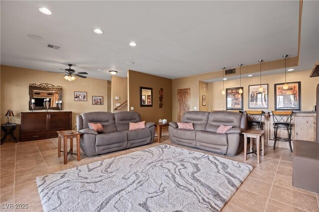 tiled living room featuring ceiling fan