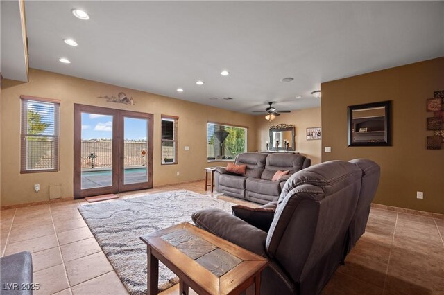 tiled living room with ceiling fan and a healthy amount of sunlight