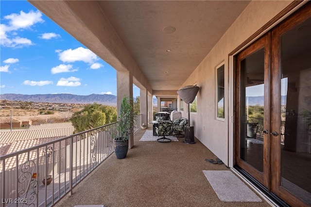 balcony with a mountain view and french doors