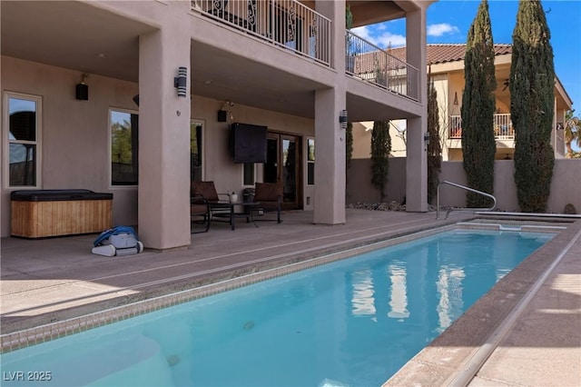 view of pool featuring a patio area and a hot tub