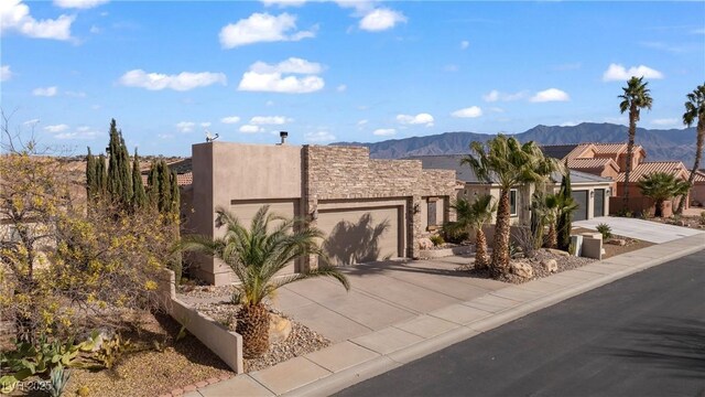 view of front facade with a mountain view and a garage