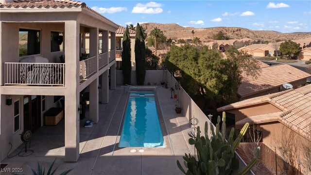 view of pool featuring a mountain view and a patio area